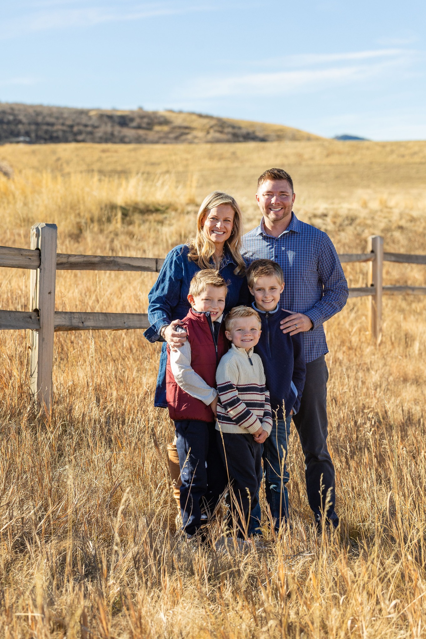 Dane with his wife and their three boys outdoors in Colorado